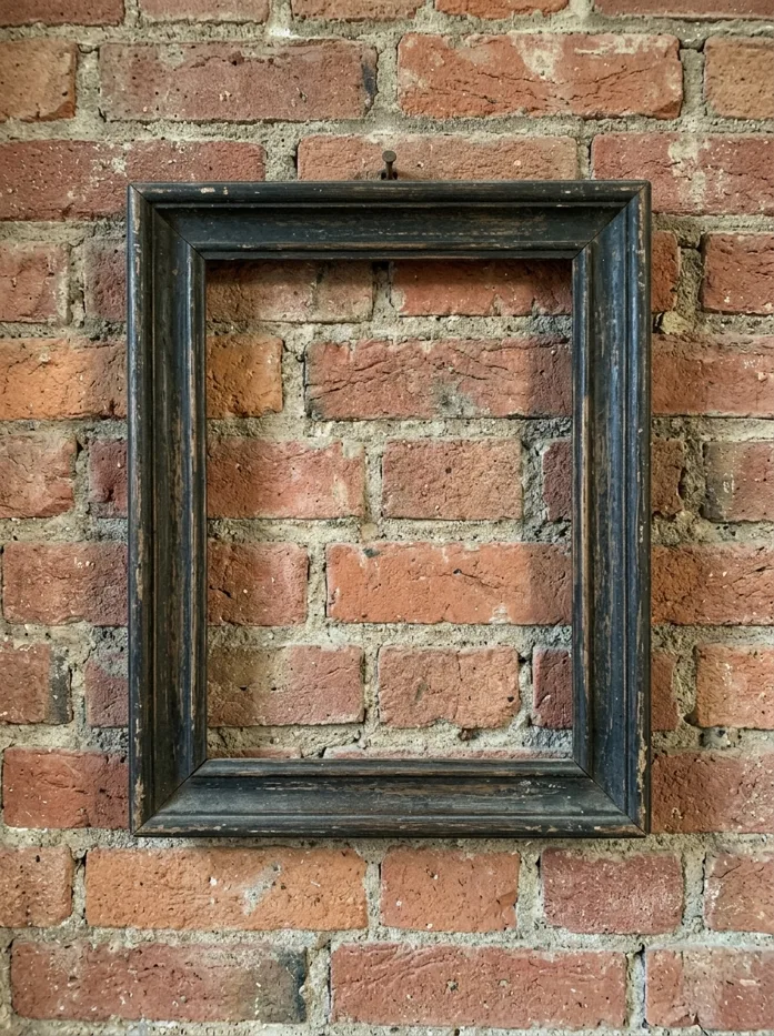 Generated example: an empty picture frame on a brick wall