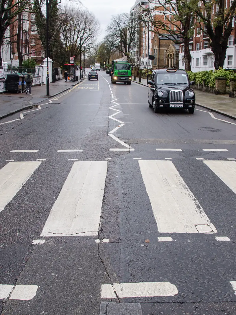 The zebra crossing on Abbey Road, London, a black cab waiting
